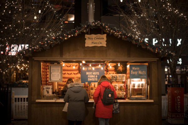 2 ladies purchasing items at a vendor at the Ottawa Christmas Market